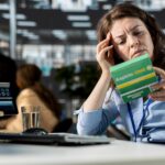 Female worker checking aspirin box label in order to cure migraine